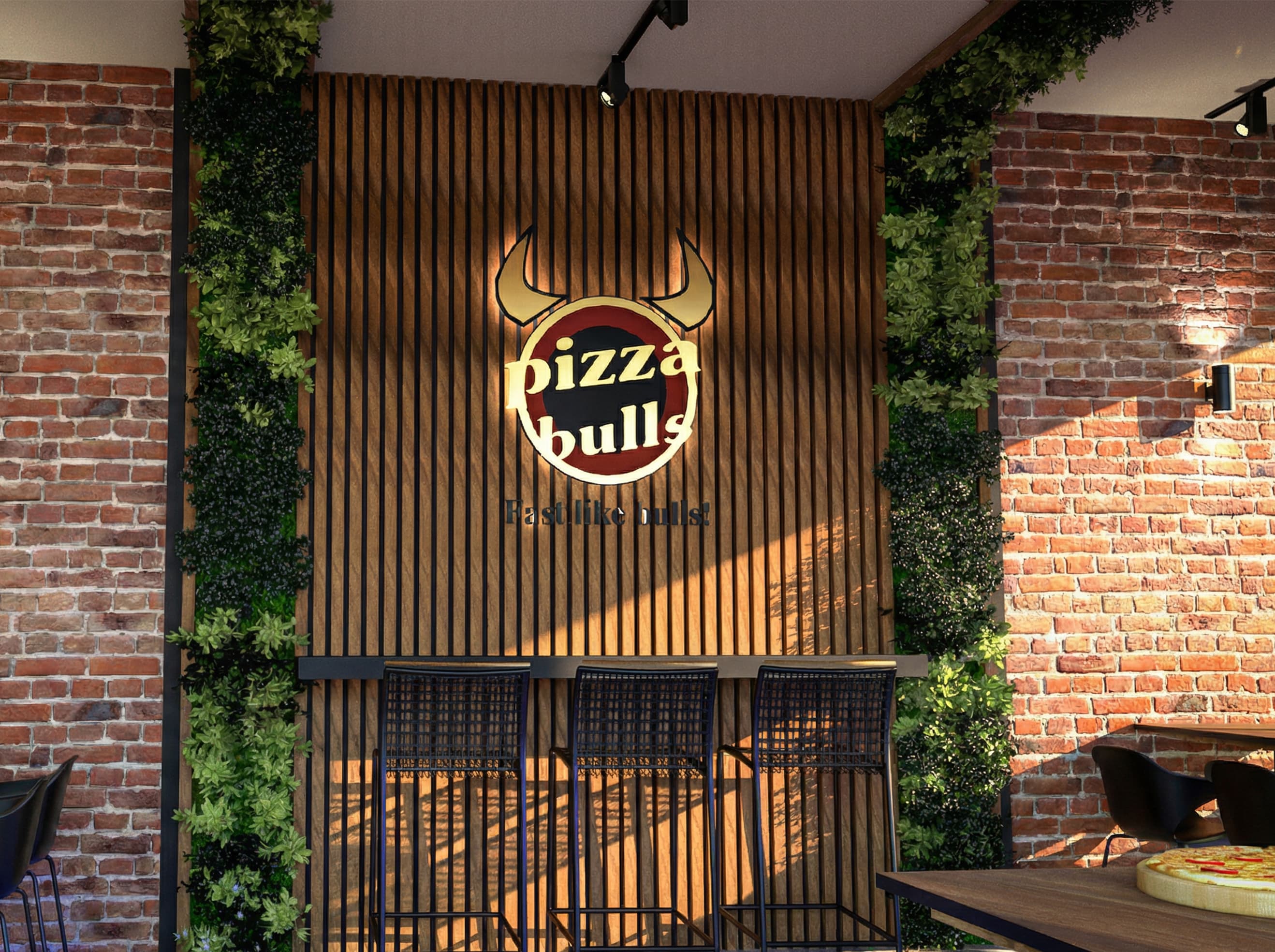 Pizza Bulls Logo an einer Holzlamellenwand mit Backsteinwänden, Pflanzen und Barhockern